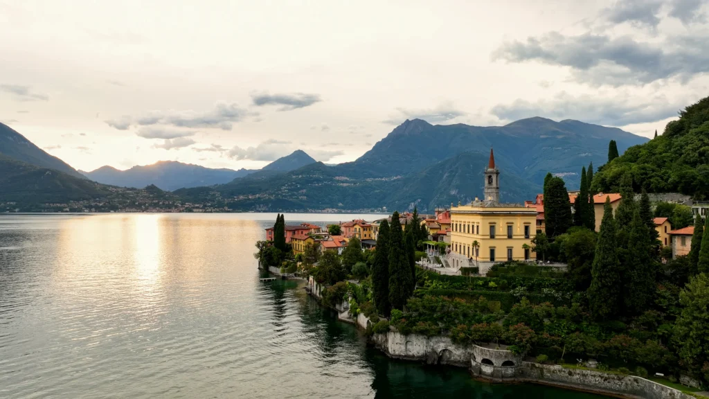 Lakeside buildings and gardens with mountains across Lake Como