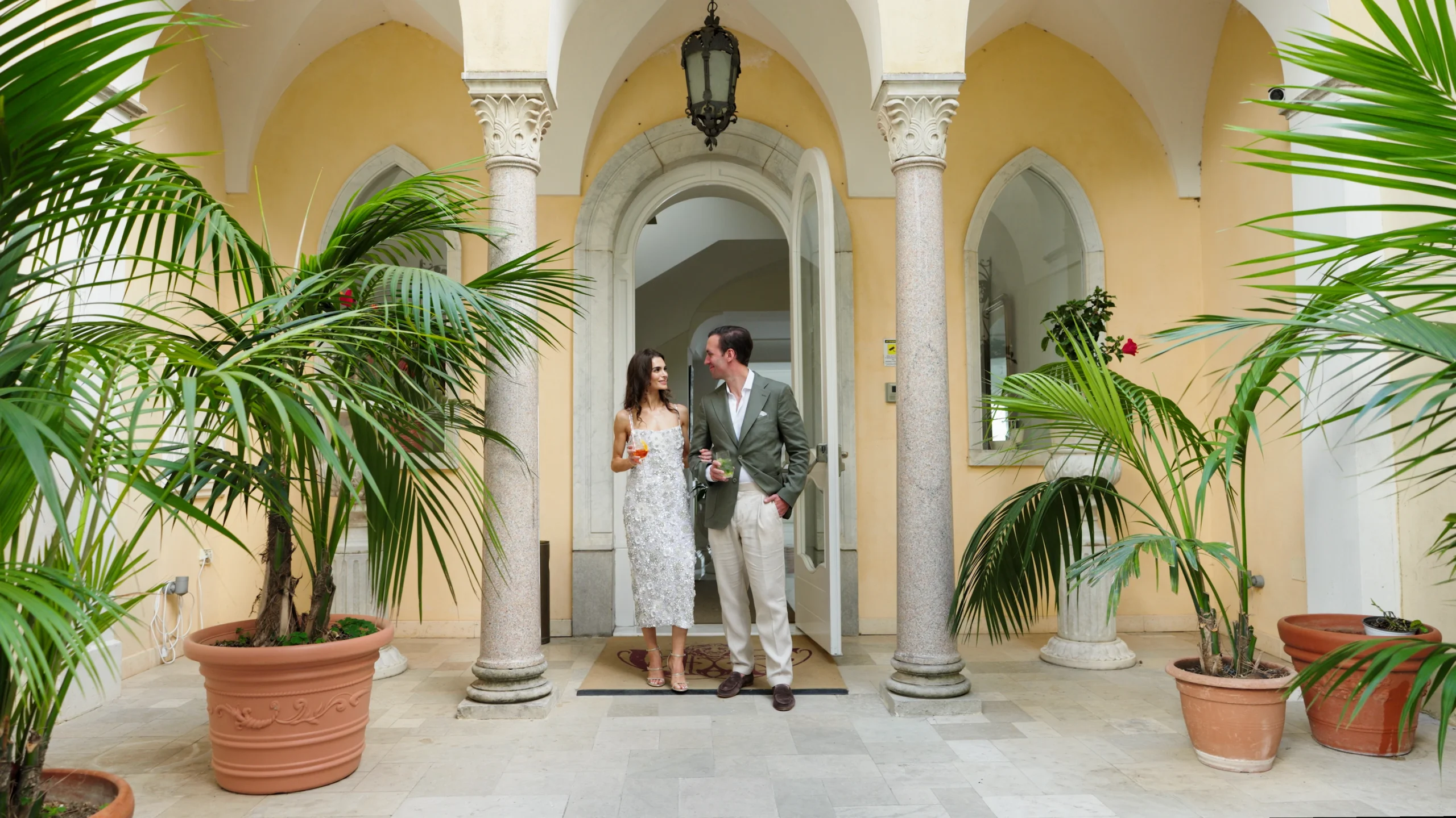 Alessandra and Alex beneath an arched doorway in Ravello